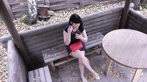 Voyeur with a secret camera spying on dark haired outdoors. Outside pee and