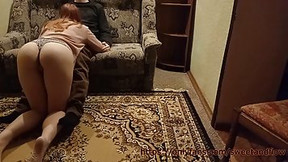 Red haired girl is kneeling on the floor while sucking her landlord