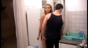 Poor dude must clean kitchen on order of his mistress