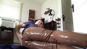 Man masturbating in his brown leather pants and plastic underwear filled with lube