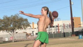 Outdoors video of sexy brunette Danielle playing basketball topless