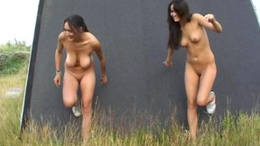 Sweeties are posing naked on the empty field