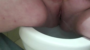 Big fat blonde girl showing off her fat pussy while pissing in the toilet