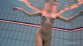 Long legged beauty underwater in the pool